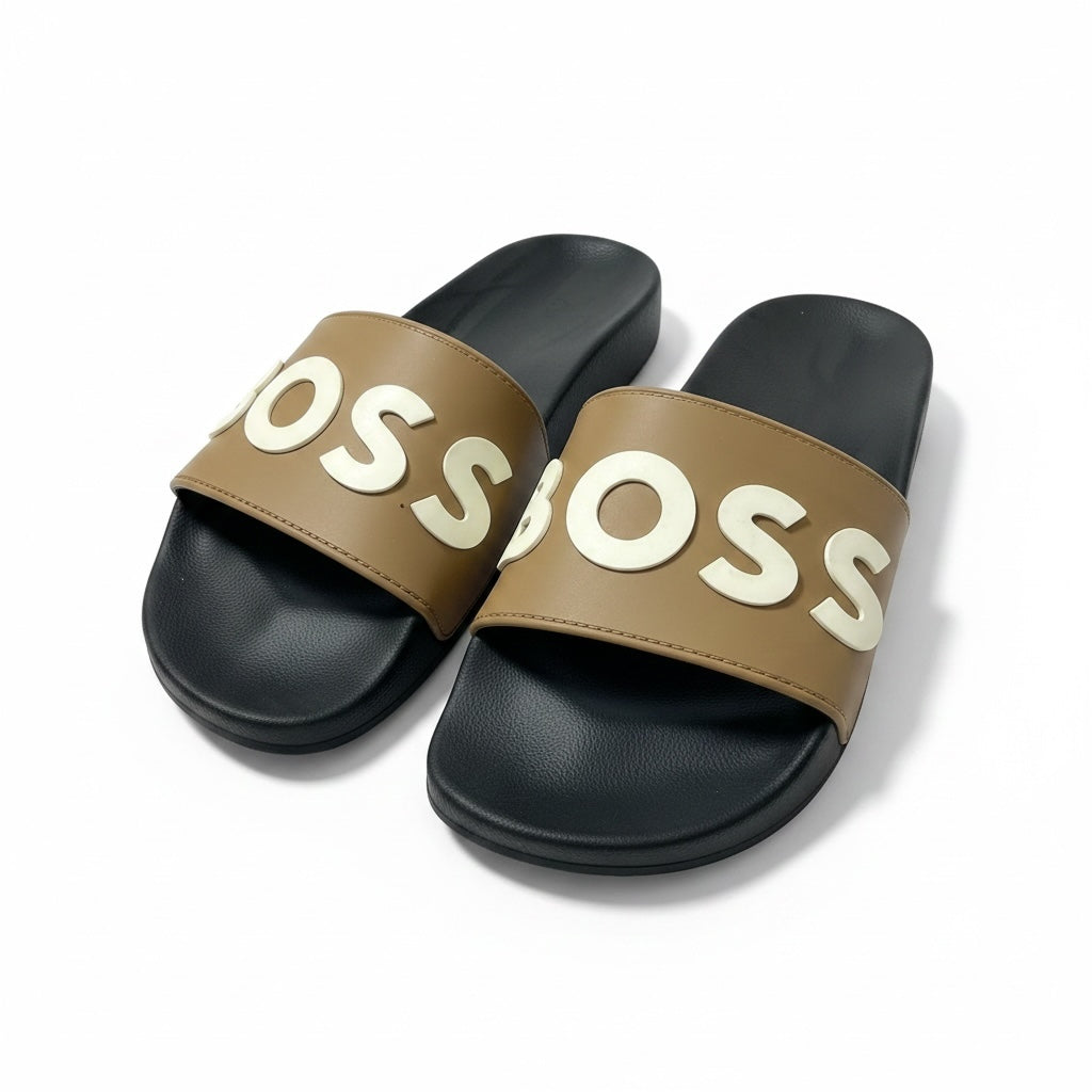 picknpack BOSS tan slide sandals with a black contoured footbed and bold white embossed logo on the strap