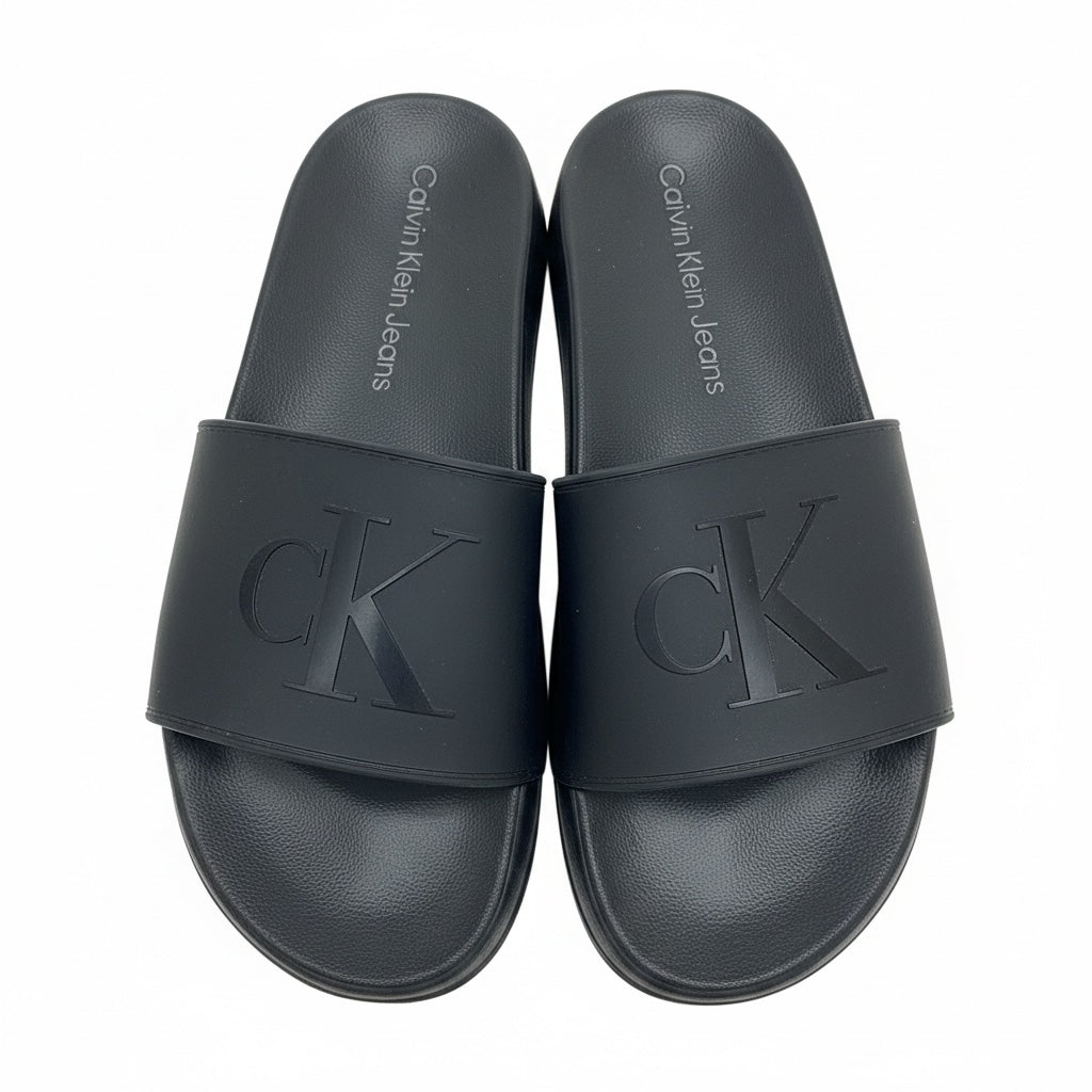 picknpack Calvin Klein Jeans black synthetic slide sandals with embossed logo on wide strap and contoured footbed
