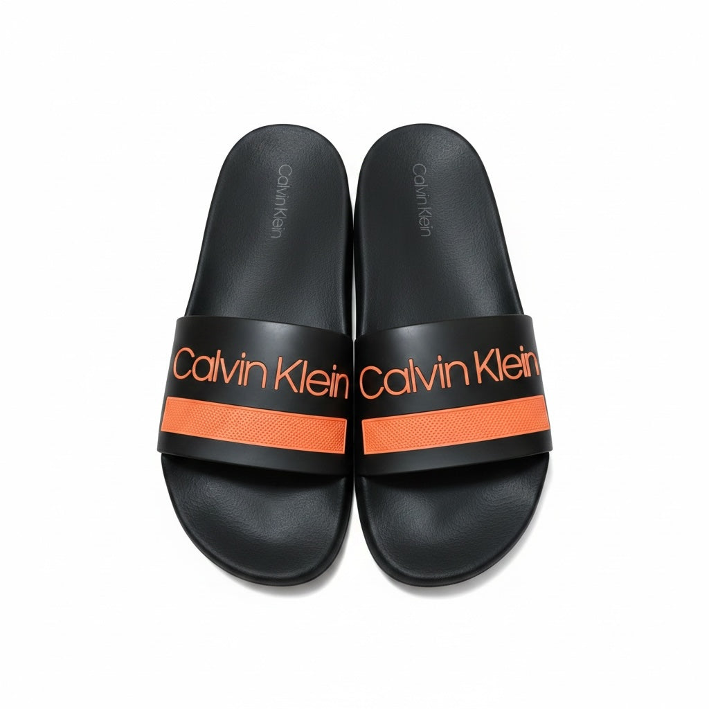 picknpack Calvin Klein black pool slide sandals with vibrant orange strap and logo branding on a contoured footbed