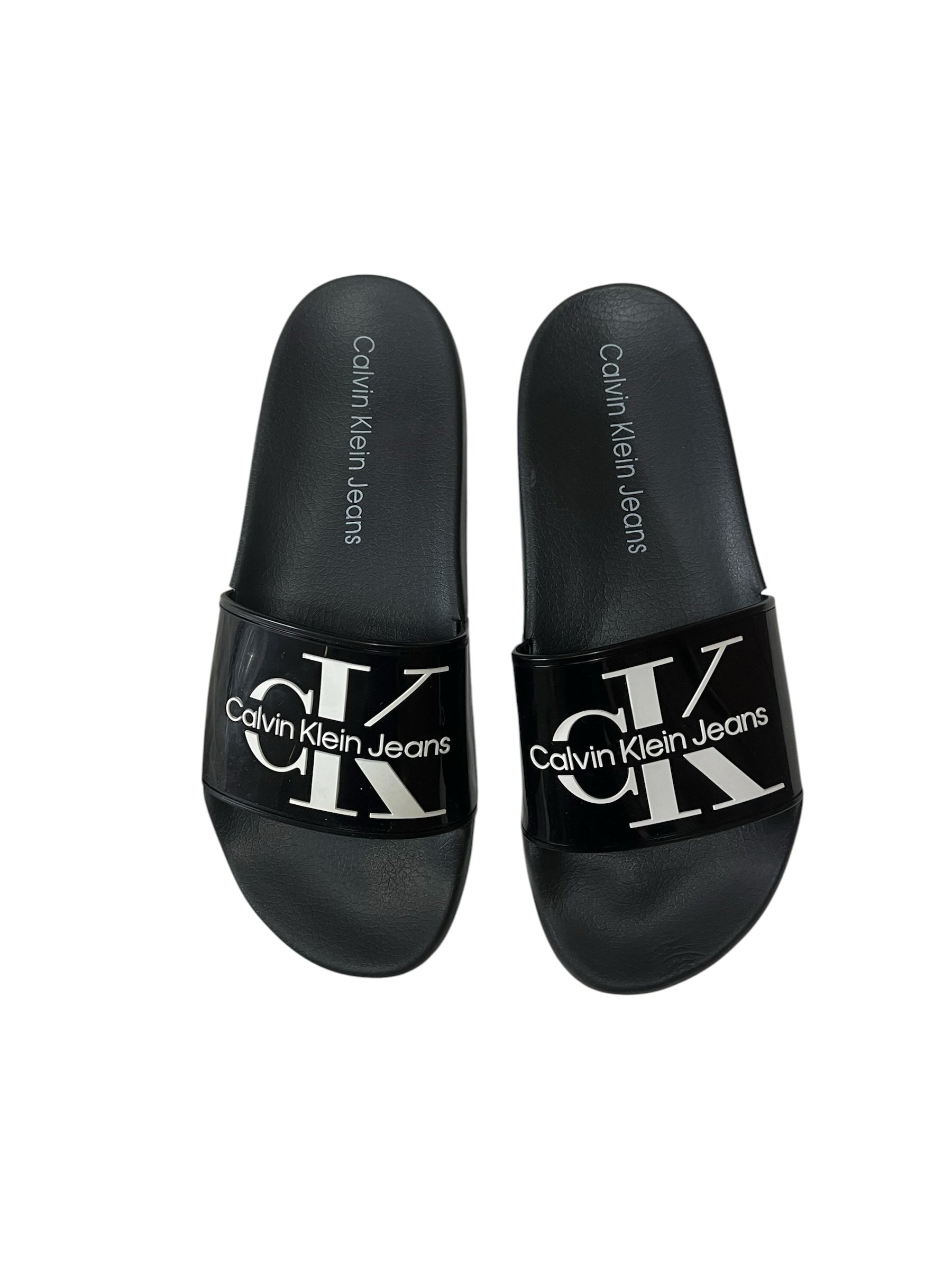 picknpack Calvin Klein Jeans black synthetic pool slides with white logo branding on the strap and contoured footbed