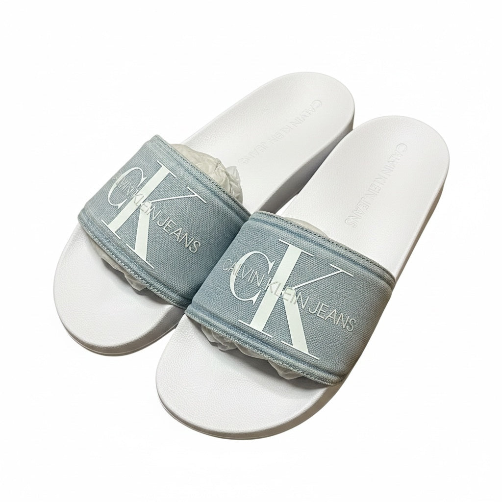 picknpack Calvin Klein Jeans pool slide sandals featuring a muted blue textured strap and white contoured footbed.