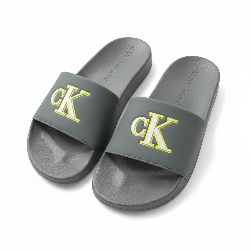 picknpack Calvin Klein Jeans grey pool slide sandals with a yellow ck logo on the strap and contoured footbed