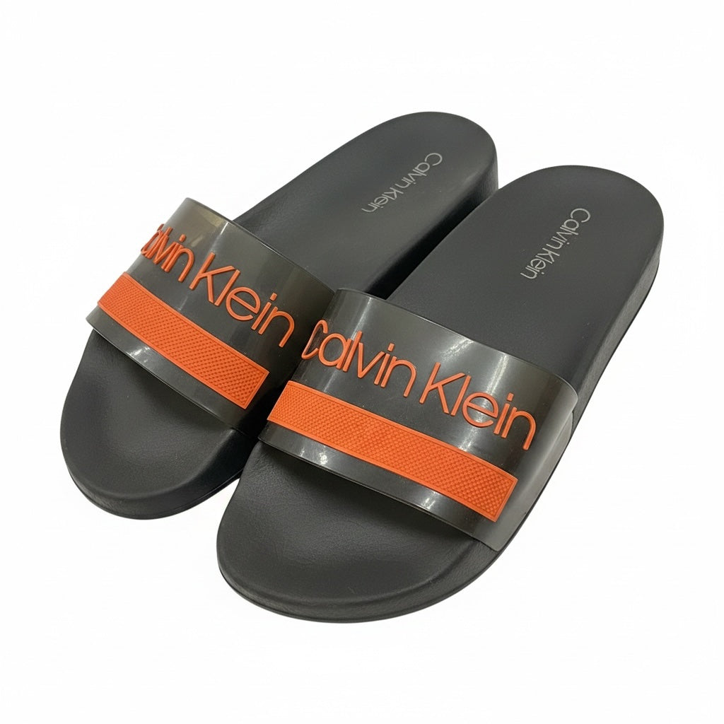 picknpack Calvin Klein dark grey translucent pool slide sandals with vibrant orange logo strap and contoured footbed