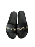 picknpack Hollister black pool slide sandals with gold logo lettering on the wide strap