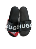 picknpack HUGO black rubber pool slides with bold white embossed logo on the strap and a red brand tag attached