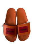 picknpack HUGO orange rubber pool slides with a bold red logo patch on the strap and a contoured footbed