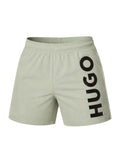 picknpack HUGO sage green athletic swim shorts with a bold vertical black logo print on the leg and elastic waistband