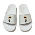 picknpack white Karl Lagerfeld slide sandals featuring a signature character graphic on the strap and embossed footbed