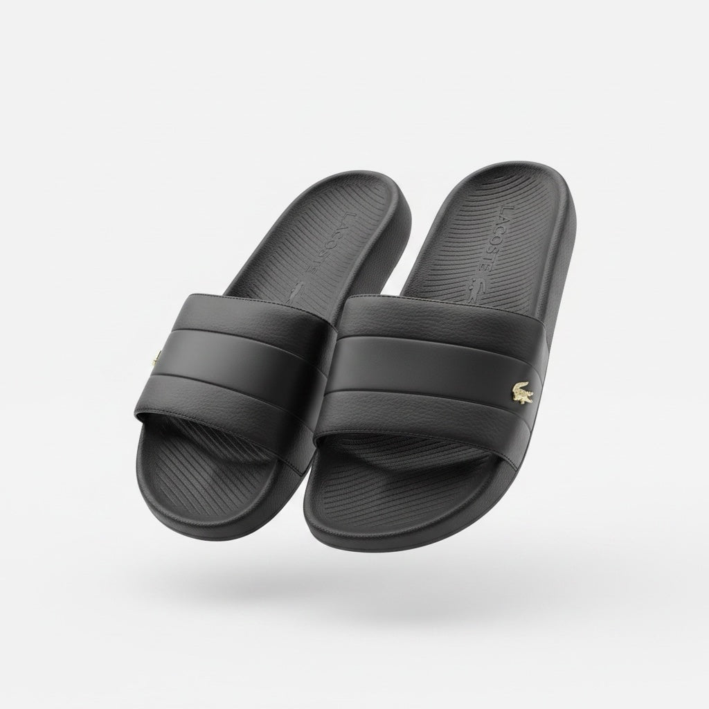 picknpack Lacoste men's black slide sandals with a textured strap and gold-tone crocodile logo on a white background