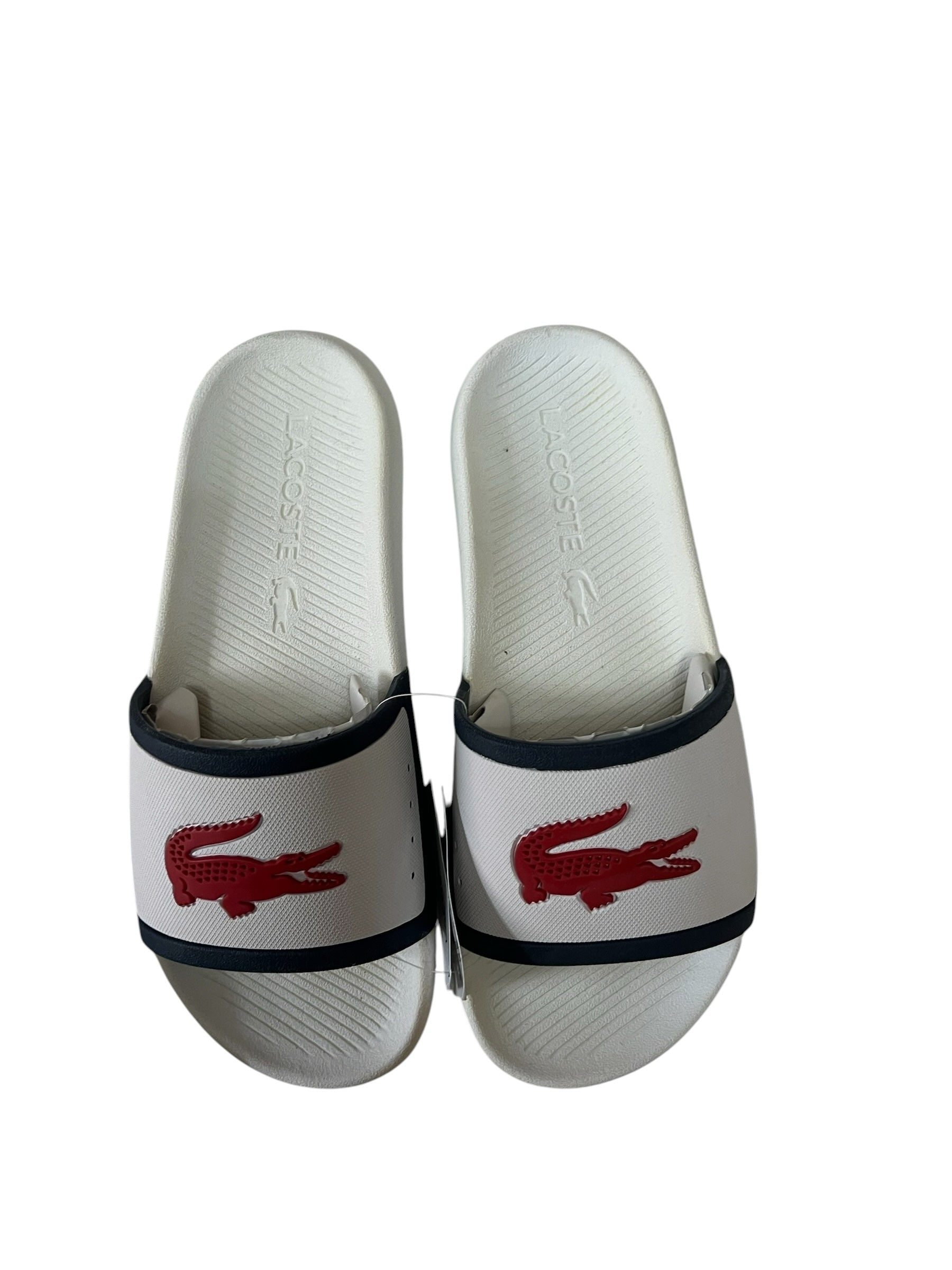 picknpack Lacoste white slip-on sandals with a red crocodile logo on the strap and a contoured footbed.