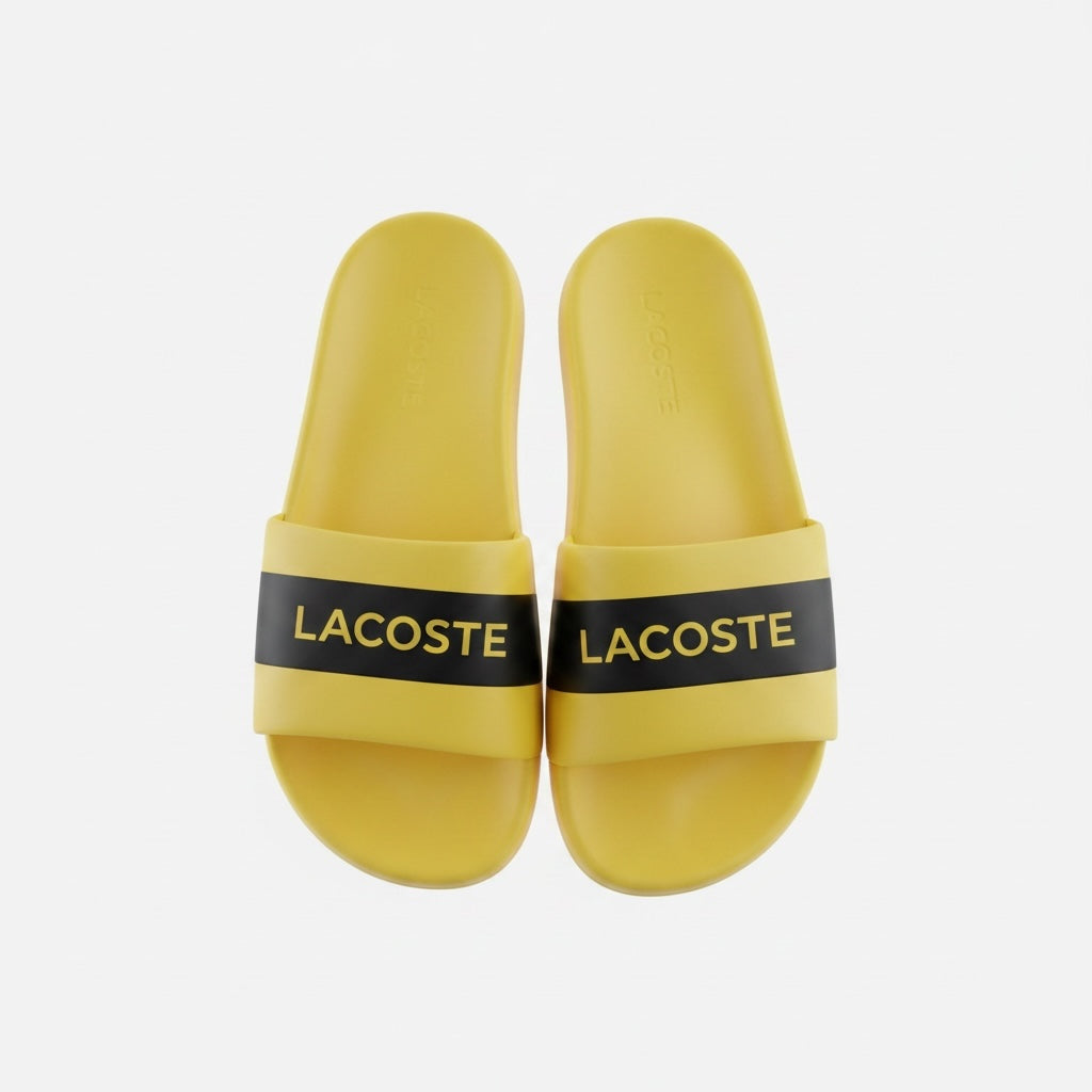 picknpack Lacoste yellow pool slide sandals with a black strap and prominent brand lettering