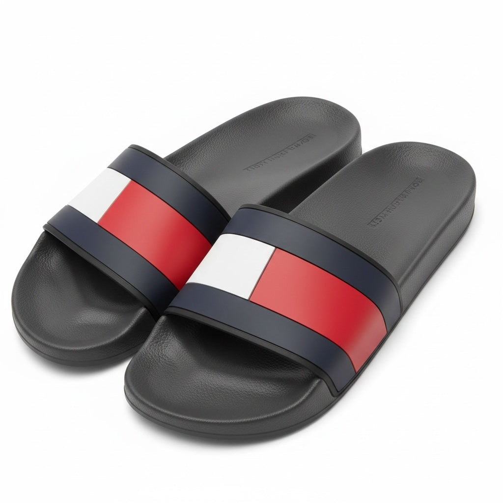 picknpack Tommy Hilfiger black pool slide sandals with signature red, white, and navy flag branding on the strap.