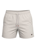 picknpack Tommy Hilfiger stone-colored swim shorts with an elastic drawstring waist and iconic flag logo patch.