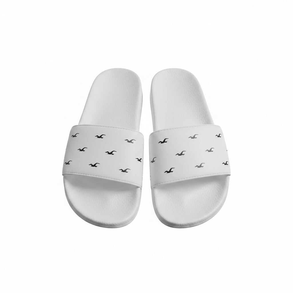 picknpack white Hollister slide sandals with a repeating black logo pattern on the wide strap and contoured footbed